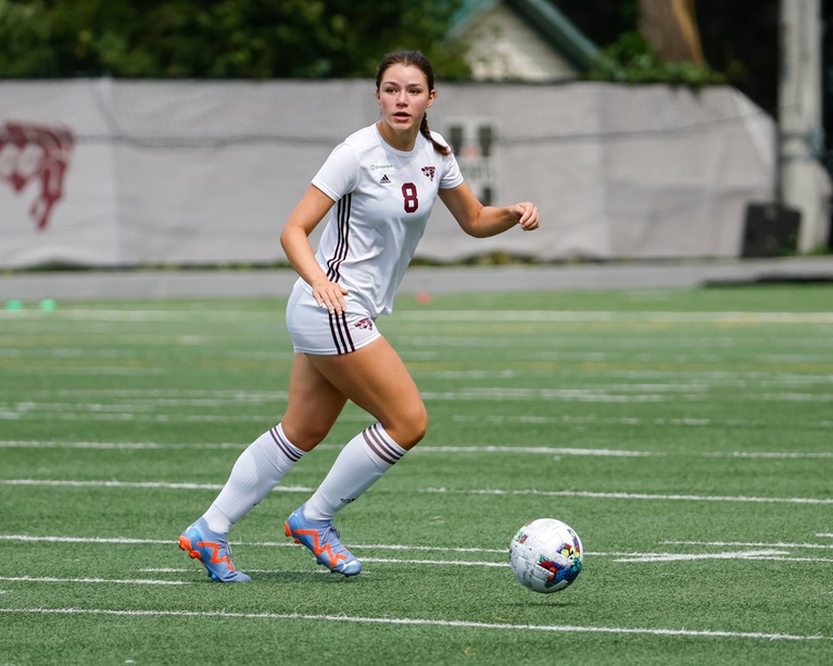 Soccer player Gabrielle Ferland looks up the field with the ball at her feet.