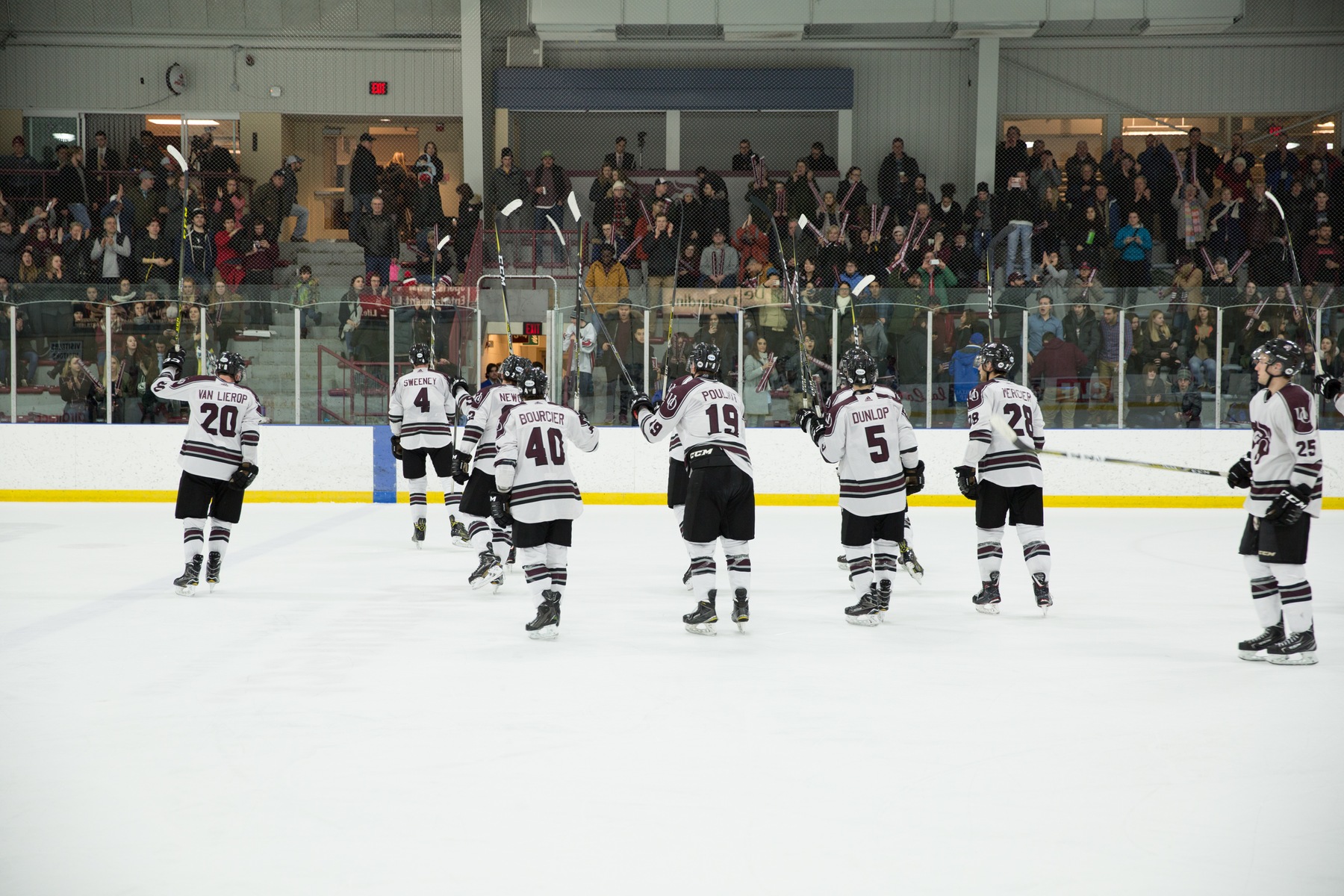 Gee-Gees hockey players salute fans after win.