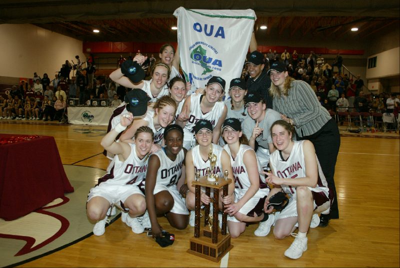 Team with OUA banner and trophy at Montpetit Hall.