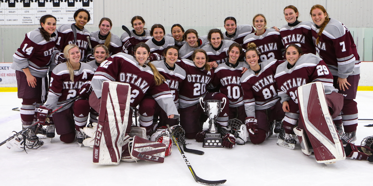 Gee-Gees team poses on ice with Alerts Cup.