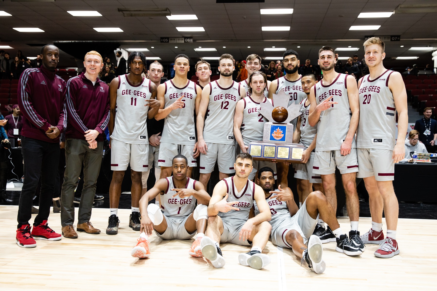 Gee-Gees men's team with the event trophy.