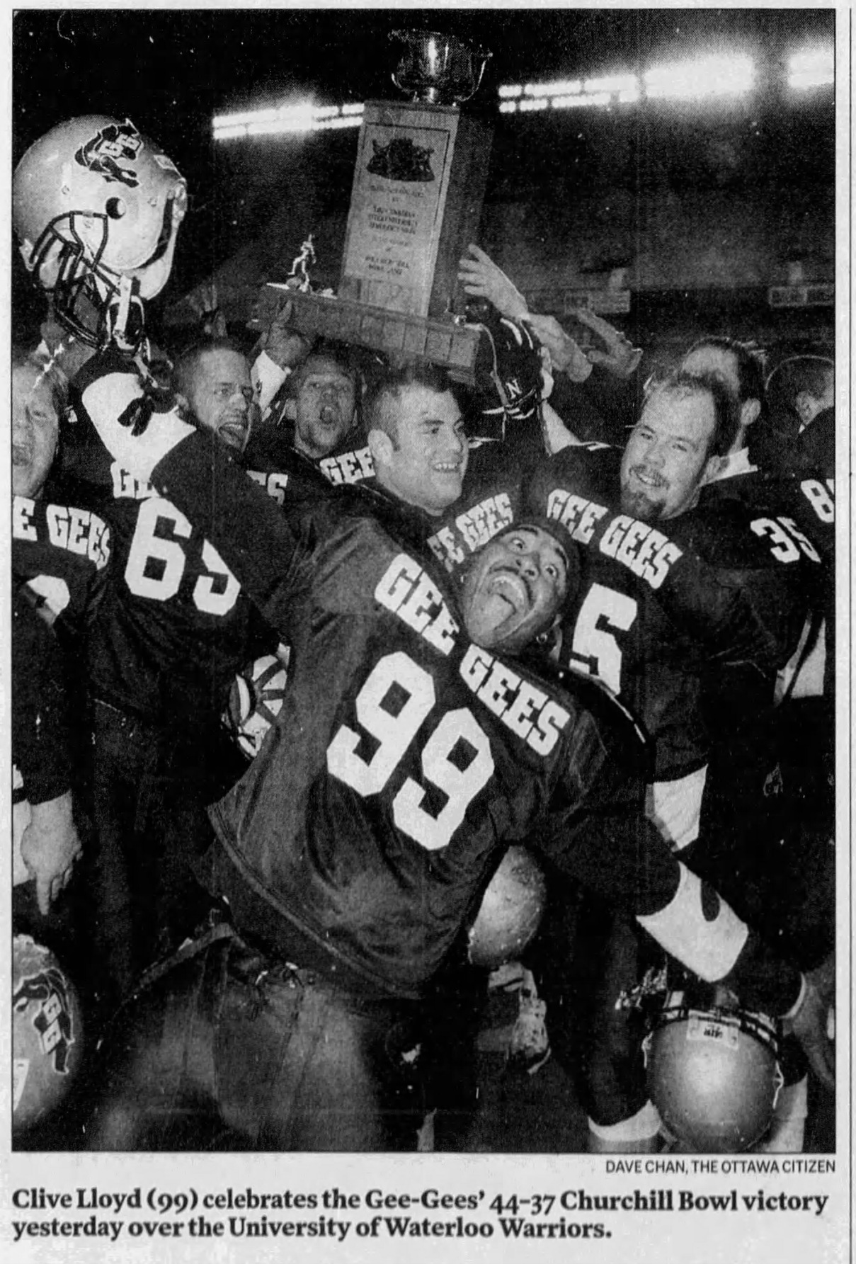 Black and white newspaper clipping with caption:Clive Lloyd (99) celebrates the Gee-Gees' 44-37 Churchill Bowl victory yesterday over the University of Waterloo Warriors. Dave Chan, the Ottawa Citizen.
