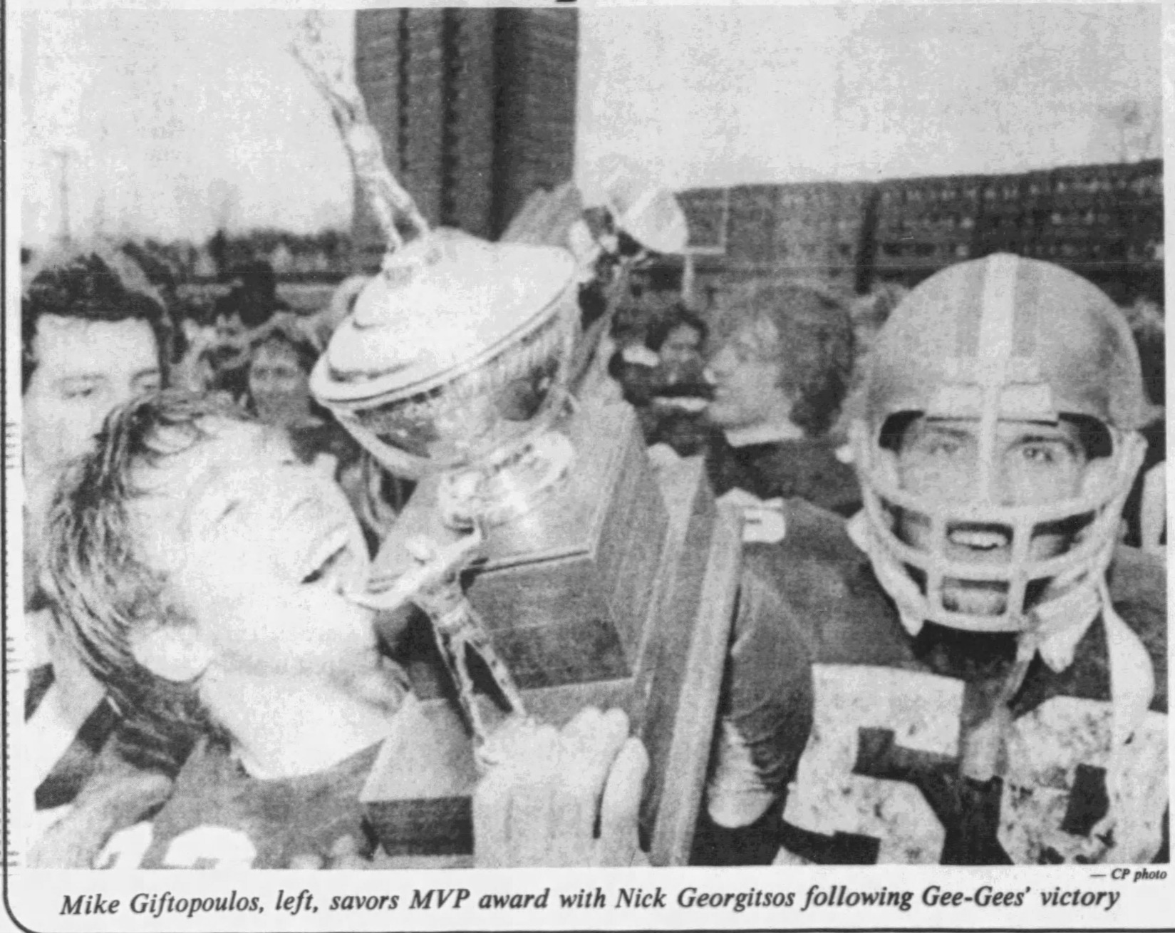Black and white newspaper clipping with the caption: Mike Giftopoulos, left, savours MVP award with Nick Georgitsos following Gee-Gees' victory. CP photo.