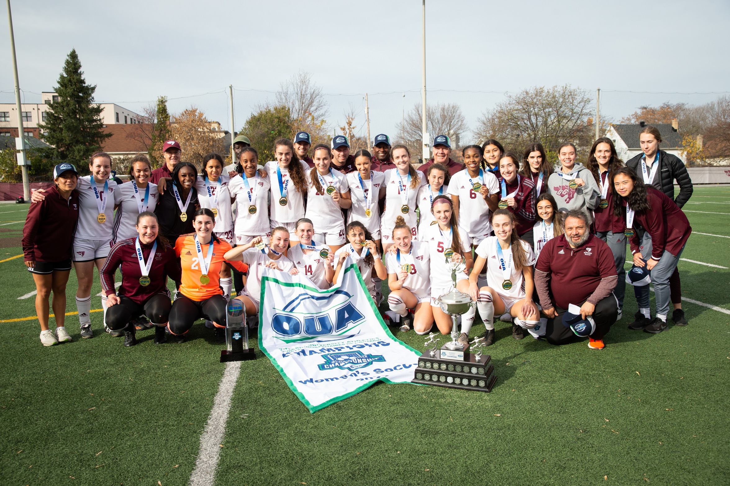 Soccer team with OUA Championship banner and trophy