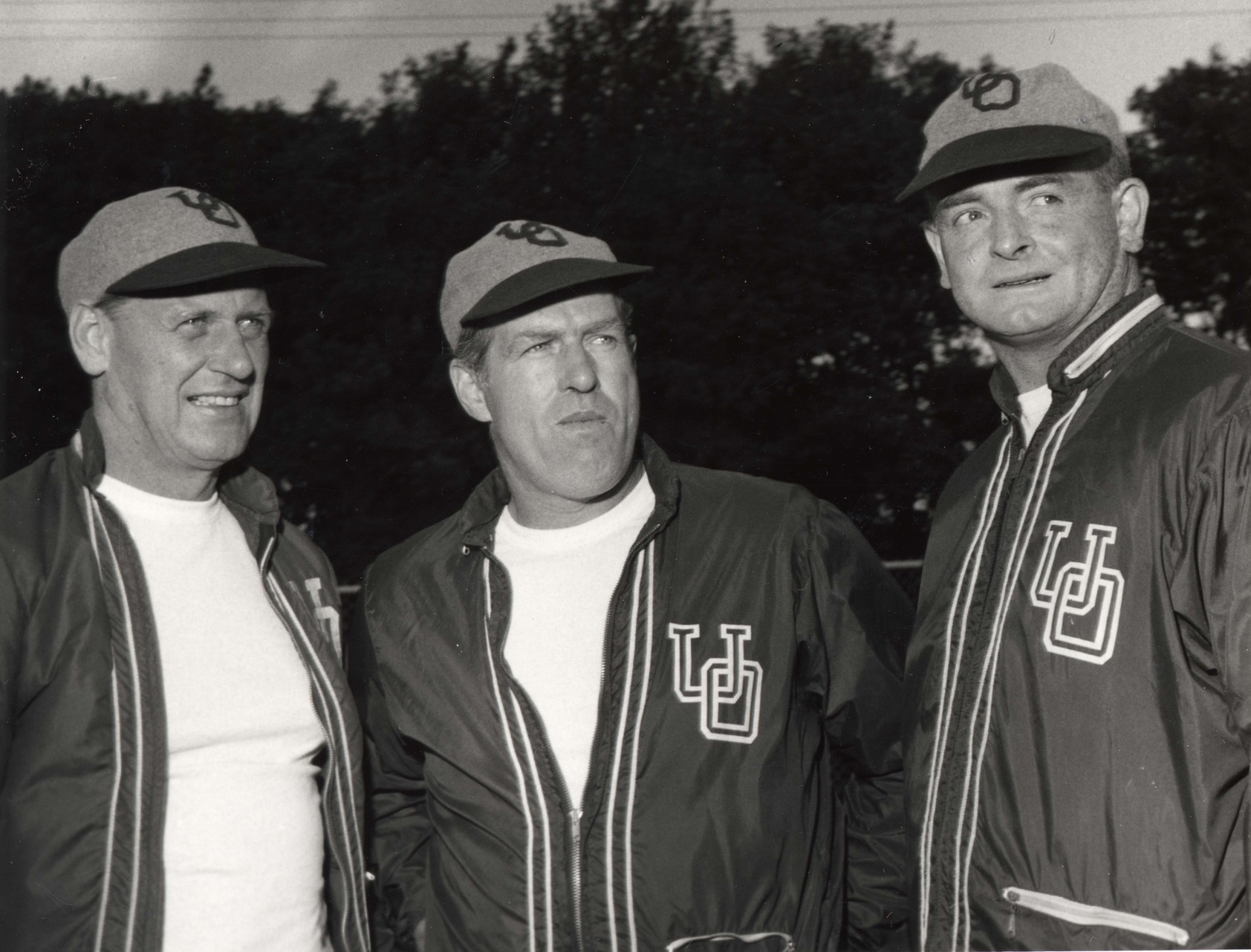 Black and white photo of three football coaches.